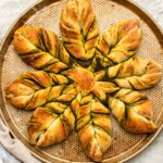 Pesto star bread on baking tray with stone background