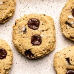 chickpea chocolate chip cookies on white speckled tray with melty chocolate