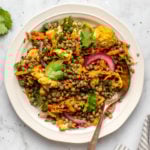 curried lentil salad on white plate and marble background