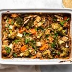 Teriyaki Tofu Rice Bake in white casserole dish topped with sesame seeds and green onion