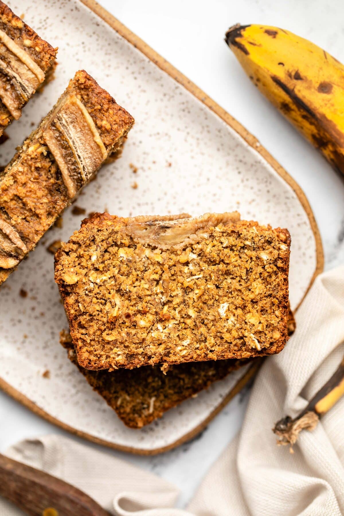 three slices of banana bread stacked on top of each other on a serving plate