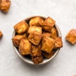 crispy tofu in white bowl on grey stone background