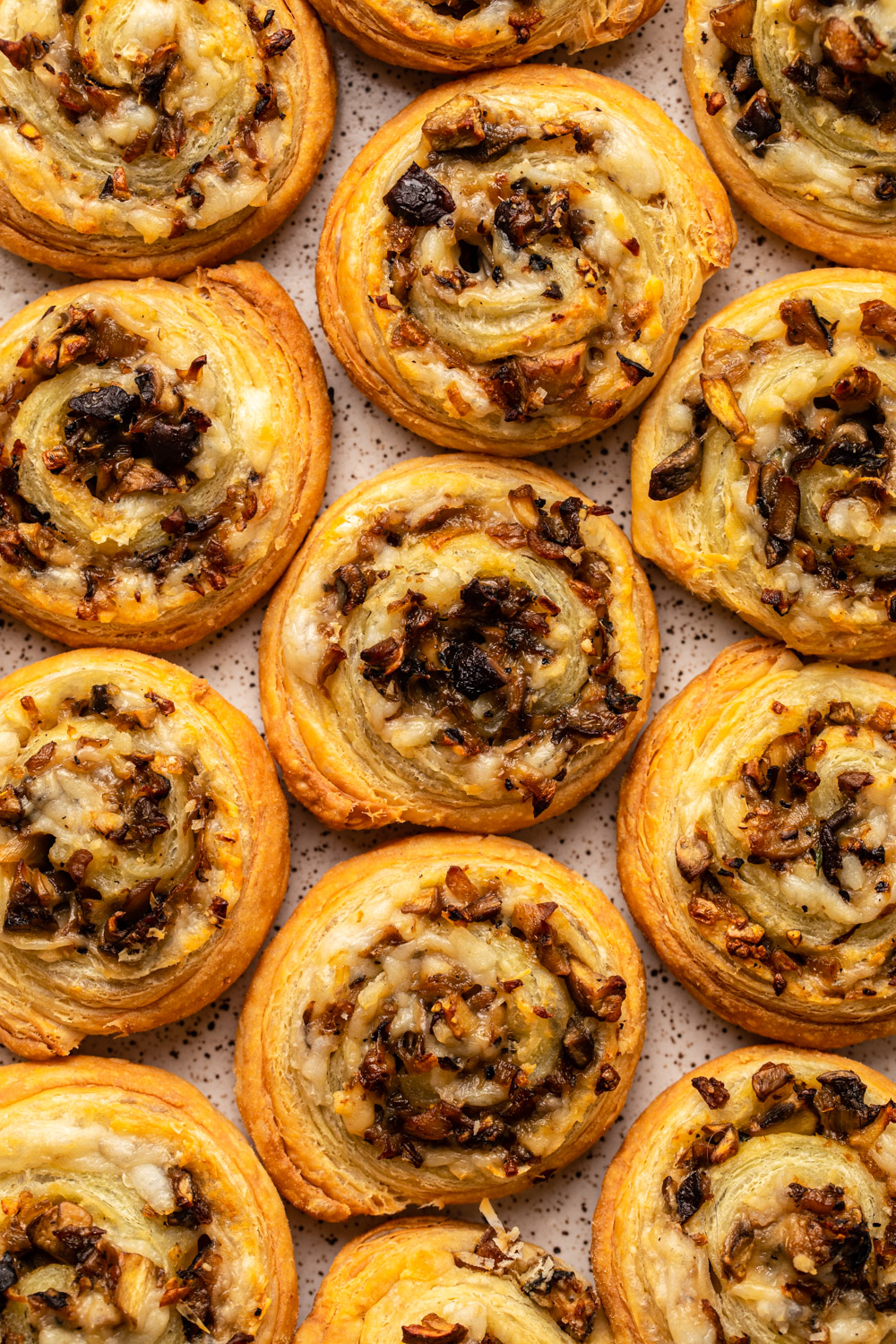 mushroom puff pastry pinwheels on white plate