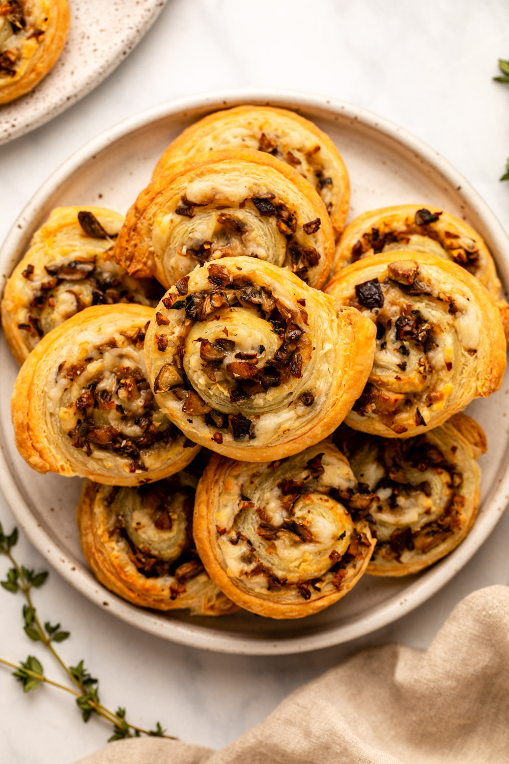 cooked mushroom pinwheels on white plate