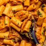 buffalo ranch pasta in saute pan with spoon scooping out some pasta