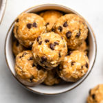 peanut butter energy bites in white bowl on white background