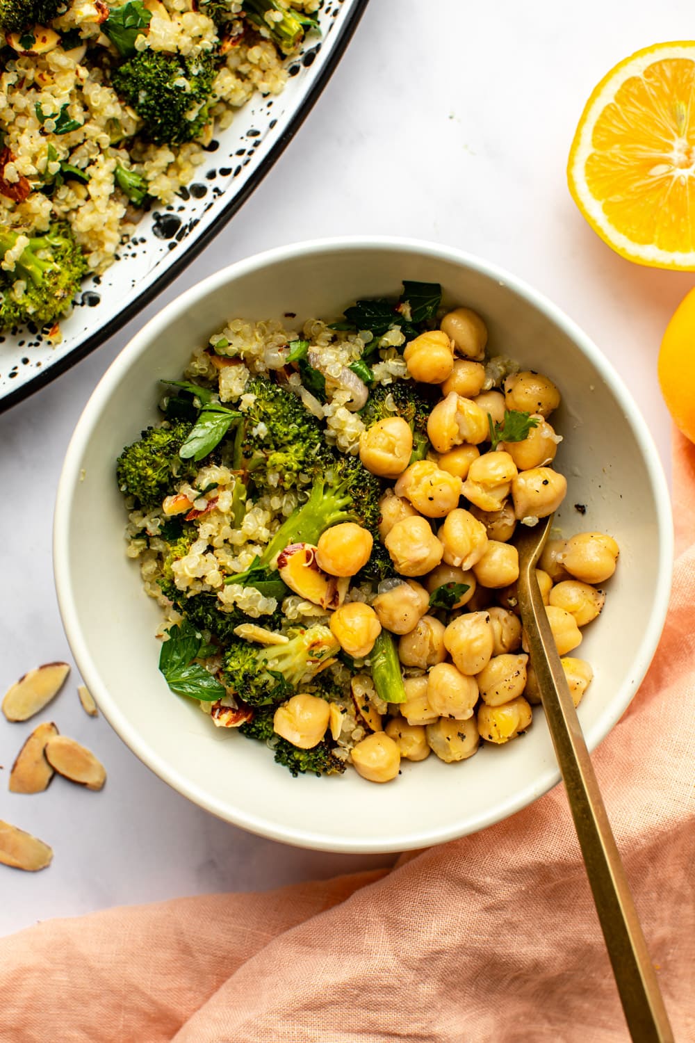 broccli quinoa salad in white bowl with chickpeas