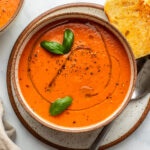roasted tomato soup topped with fresh basil and olive oil