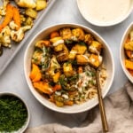 bowl of ranch tofu with roasted vegetables and rice topped with tahini sauce