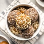 sugar free golden milk energy bites rolled in hemp and chia seeds in white bowl