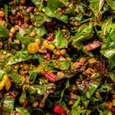 close up photo of swiss chard salad with breadcrumbs and golden raisins