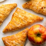 vegan apple turnover topped with glaze on marble counter