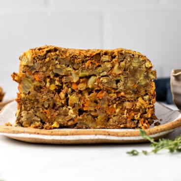 vegan lentil loaf on plate with fresh thyme