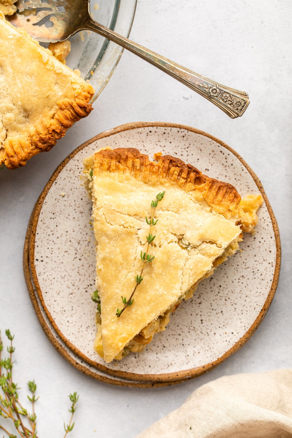 a slice of vegan pot pie cut out and served on a dotted white plate