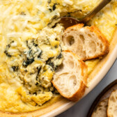 vegan spinach artichoke dip with sliced bread