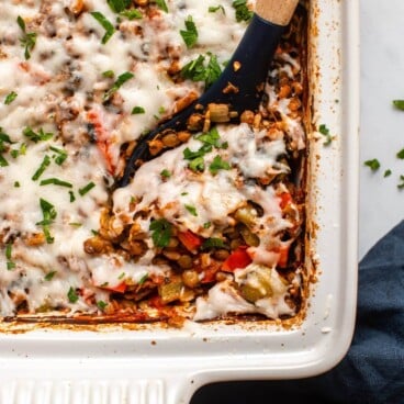 Stuffed Pepper Casserole topped with parsley with spoon scooping a serving out of it