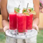 3 glasses of watermelon slushie on marble serving tray