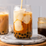 pouring milk into glass of pumpkin bubble tea