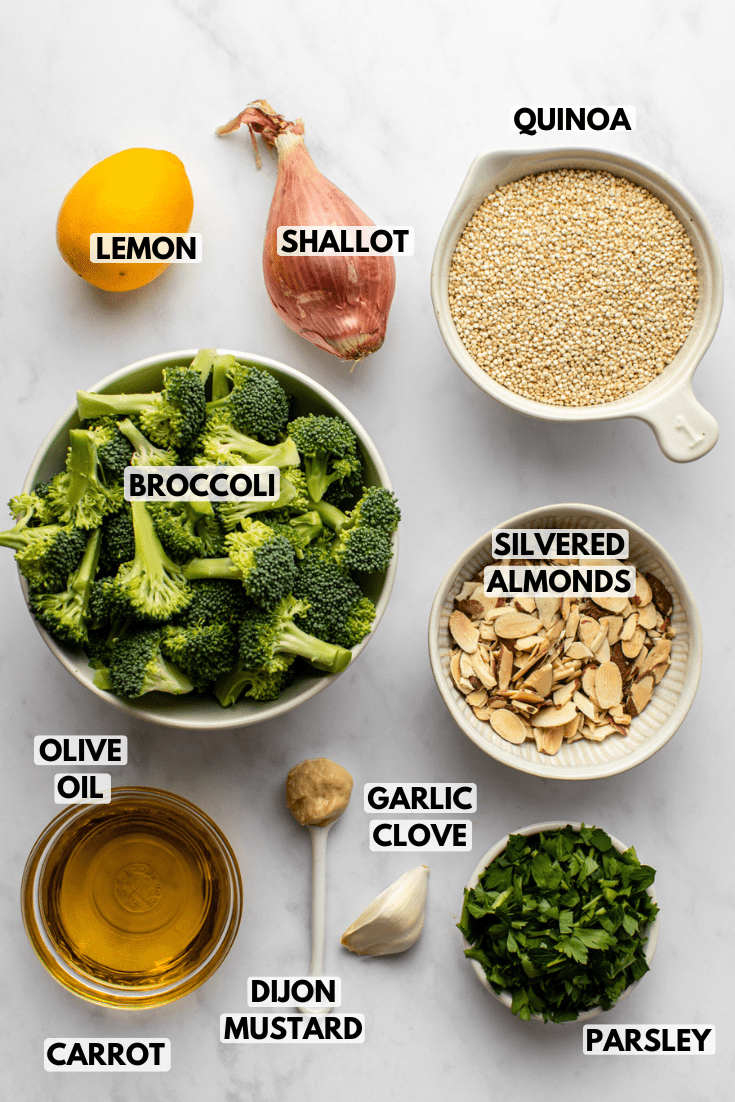 ingredients for roasted broccoli quinoa salad laid out on a kitchen countertop in various sizes of bowls