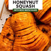 roasted honeynut squash on white serving tray topped with black pepper