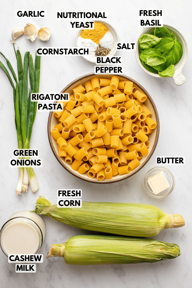 ingredients for seared corn basil pasta laid out on a marble kitchen countertop