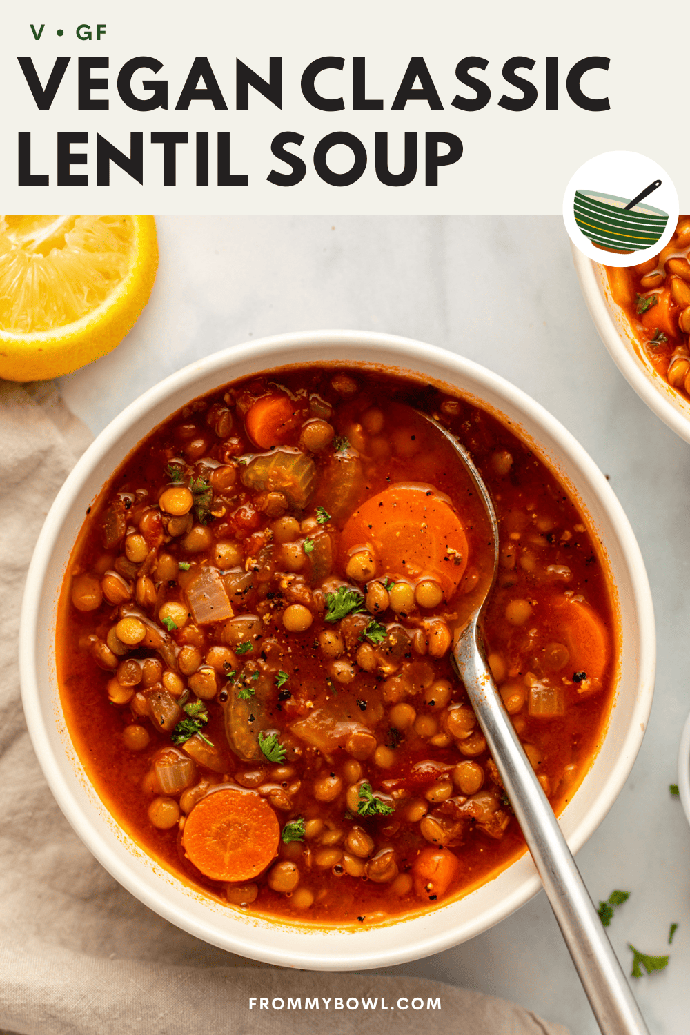 lentil soup served in a white bowl with a spoonful of it scooped up