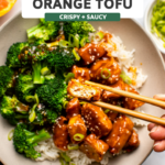 Orange tofu in bowl with white rice and broccoli