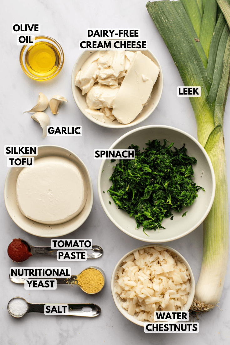 ingredients for vegan spinach dip laid out on a marble kitchen countertop